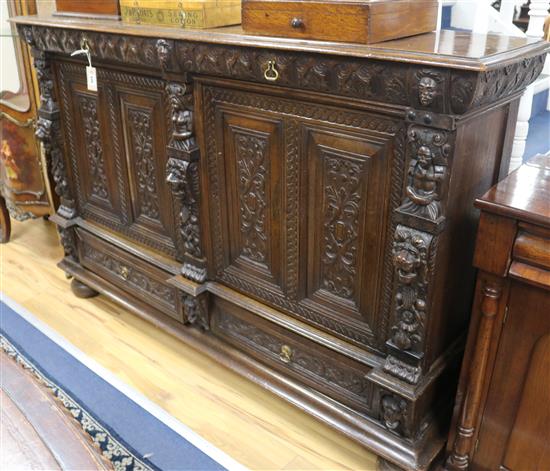 A 19th century Flemish carved oak side cabinet fitted drawers and cupboard, 170cm wide